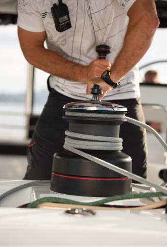 Professional crew member operating yacht equipment